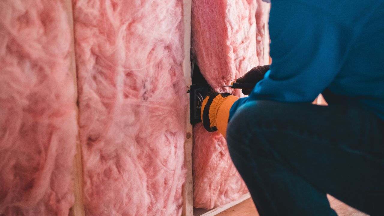 A professional installing home insulation